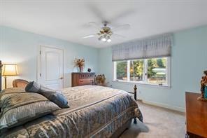 335 Red Oak Court, Unit 335 Monroeville, PA 15146 - Photo 17 of 50 a bedroom with a large bed and a chandelier