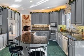335 Red Oak Court, Unit 335 Monroeville, PA 15146 - Photo 6 of 50 a kitchen with kitchen island granite countertop a stove a sink and a refrigerator