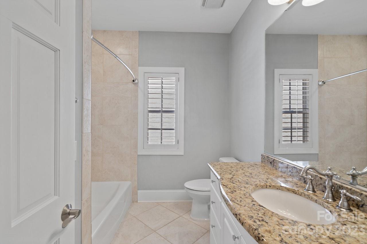 4409 Mickleton Road Charlotte, NC 28226 - Photo 16 of 31 a bathroom with a granite countertop sink a toilet and shower