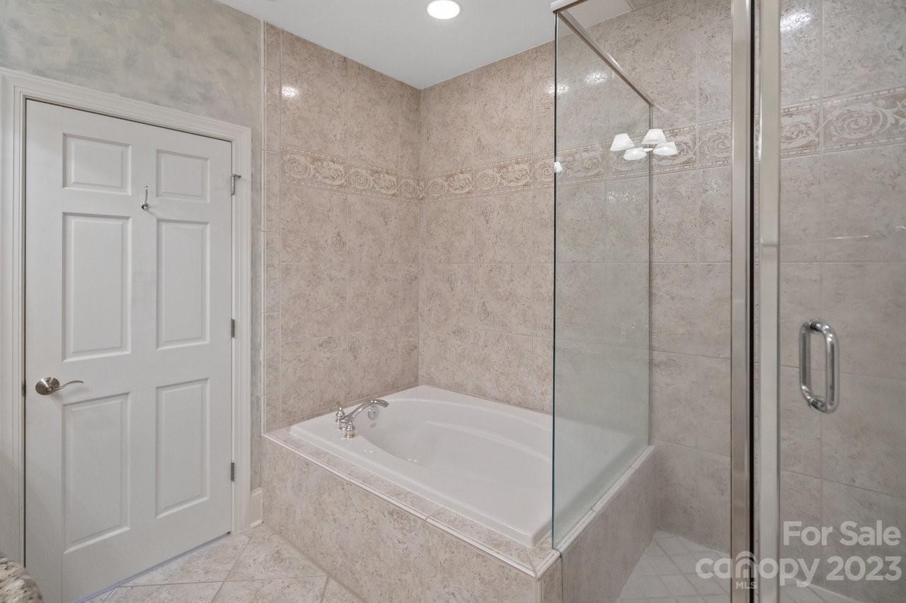 4409 Mickleton Road Charlotte, NC 28226 - Photo 22 of 31 a bathroom with a bathtub and a shower