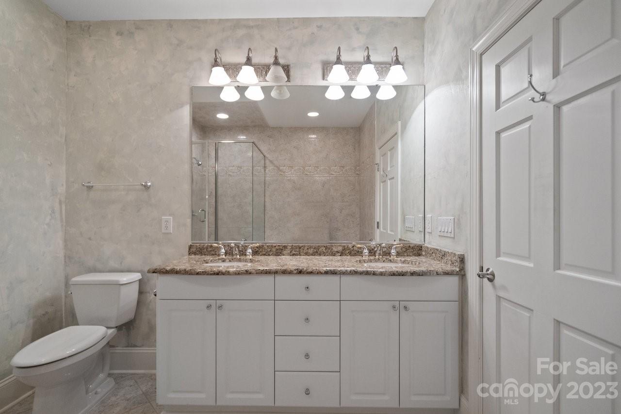 4409 Mickleton Road Charlotte, NC 28226 - Photo 23 of 31 a bathroom with a toilet sink and mirror