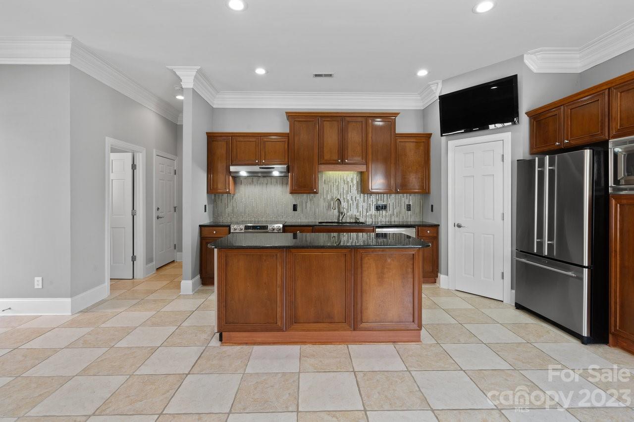 4409 Mickleton Road Charlotte, NC 28226 - Photo 25 of 31 a kitchen with stainless steel appliances granite countertop a refrigerator and a stove