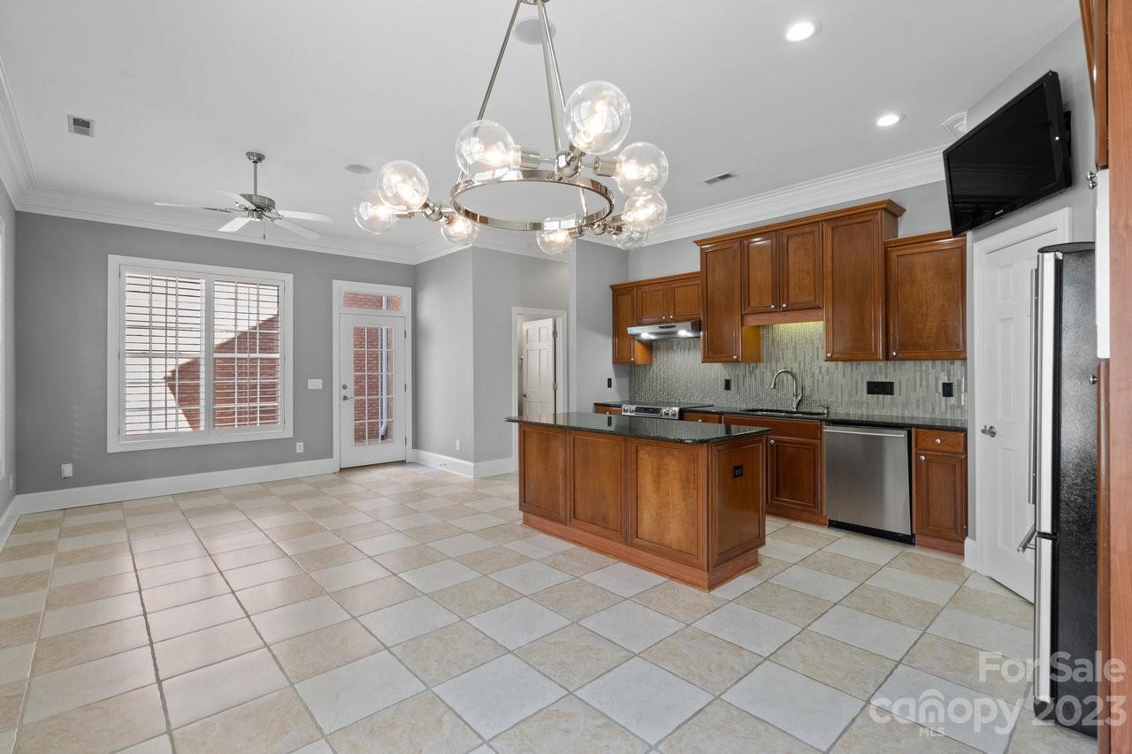 4409 Mickleton Road Charlotte, NC 28226 - Photo 26 of 31 a large kitchen with kitchen island granite countertop a refrigerator a oven a island a stove and a sink