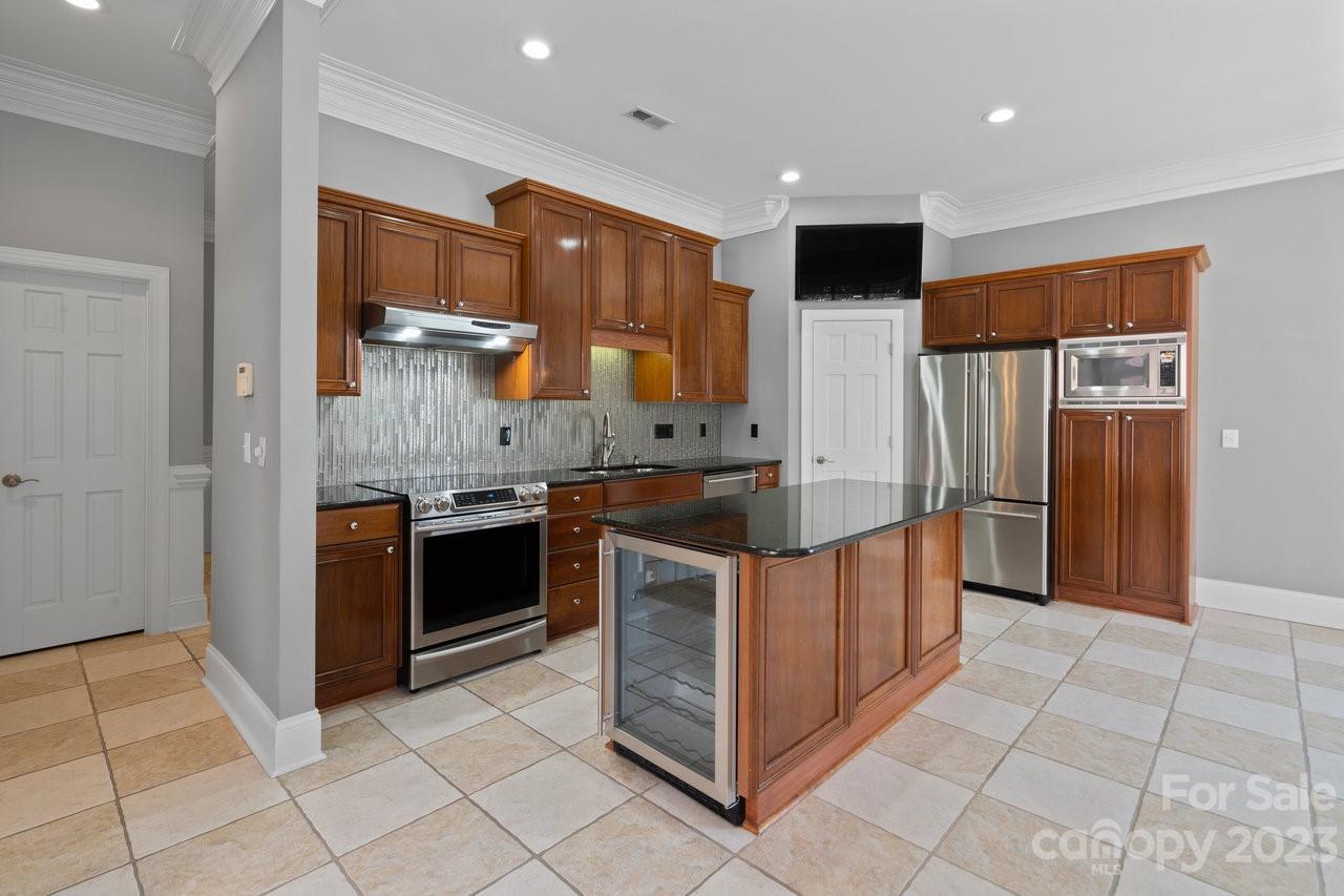 4409 Mickleton Road Charlotte, NC 28226 - Photo 4 of 31 a kitchen with stainless steel appliances granite countertop a stove a refrigerator and a sink