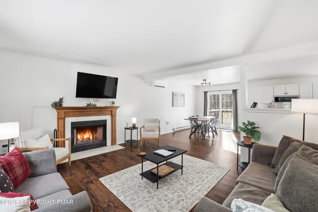a living room with furniture a flat screen tv and a fireplace
