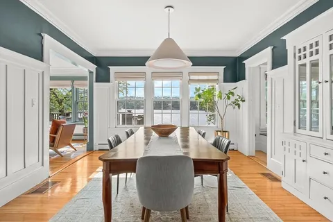 a view of a dining room with furniture window and wooden floor