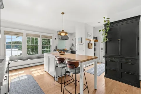 a view of a dining table chairs and entryway