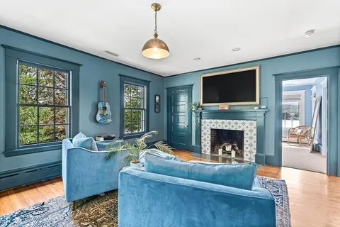 a living room with furniture and a fireplace