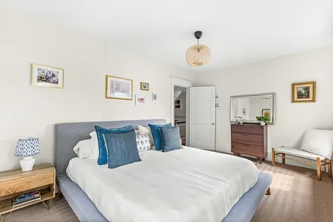 a bedroom with a bed and a chair