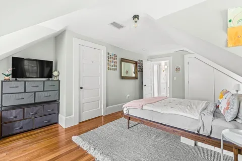 a bedroom with a bed and flat screen tv