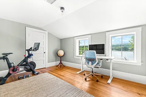 a view of a livingroom with workspace and a window