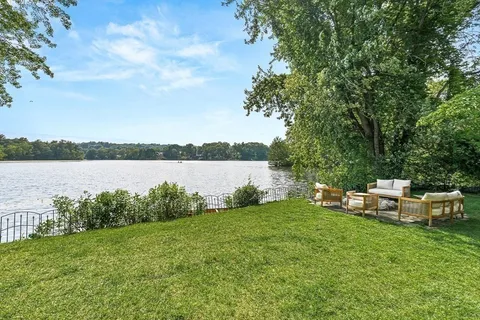 a backyard of a house with table and chairs