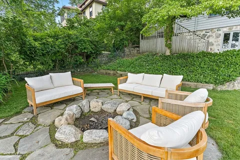 a view of a patio with couches chairs and a fire pit