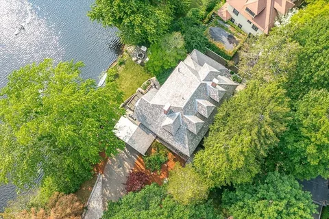 an aerial view of a house with a yard and garden