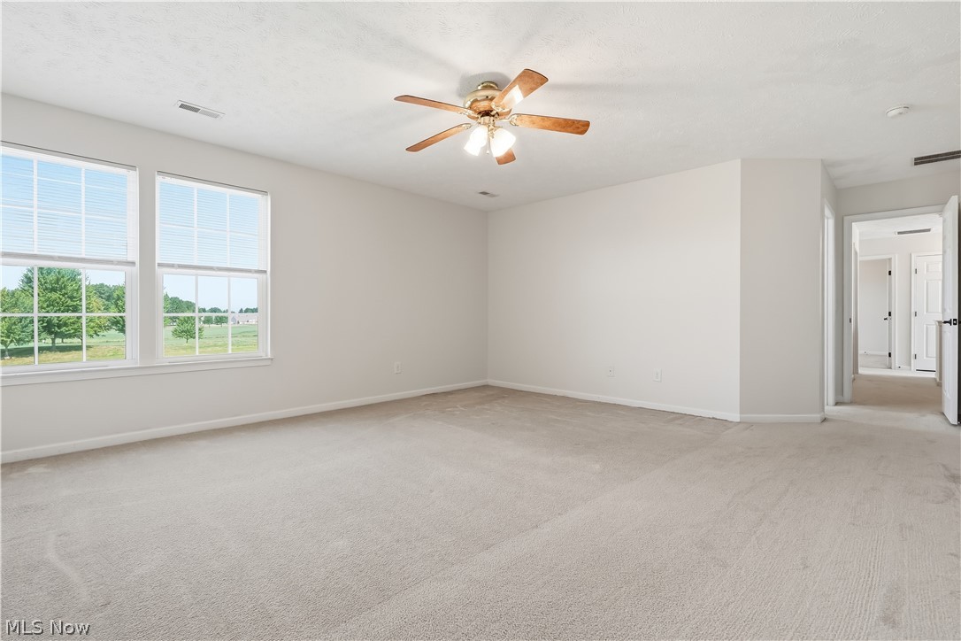 3280 Seven Bridges Road Medina, OH 44256 - Photo 30 of 41 Spacious room featuring neutral carpet, light-toned walls, and a ceiling fan with integrated lighting