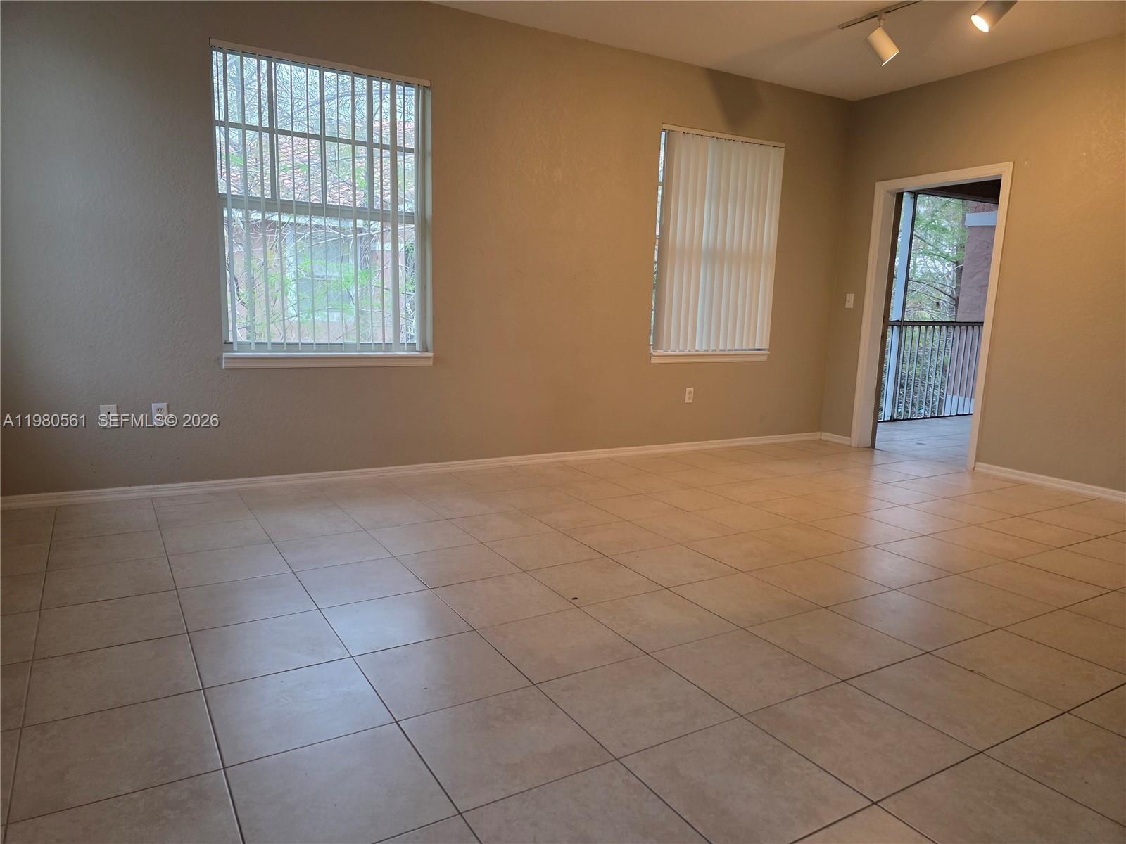6660 West Sample Road, Unit 6660 Coral Springs, FL 33067 - Photo 1 of 30 an empty room with windows and closet