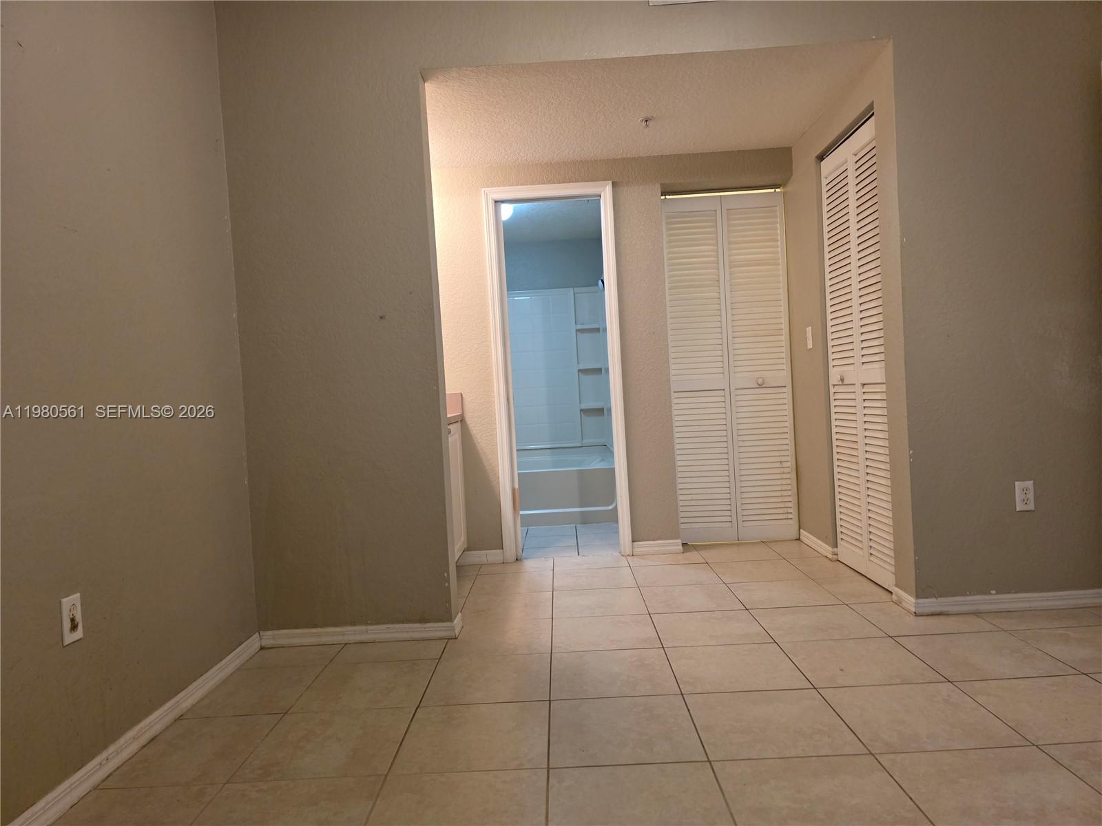 6660 West Sample Road, Unit 6660 Coral Springs, FL 33067 - Photo 13 of 30 a view of an empty room with closet and a bathroom