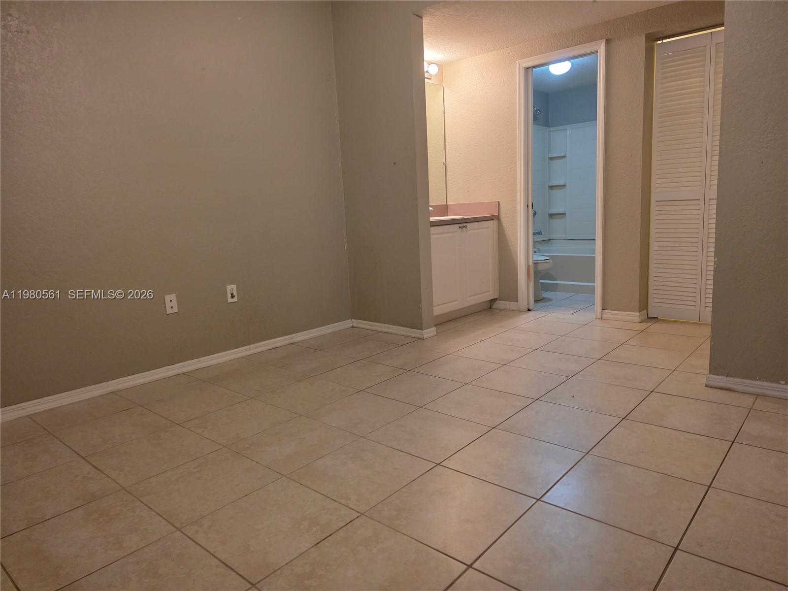 6660 West Sample Road, Unit 6660 Coral Springs, FL 33067 - Photo 14 of 30 an empty room with white walls and tiles