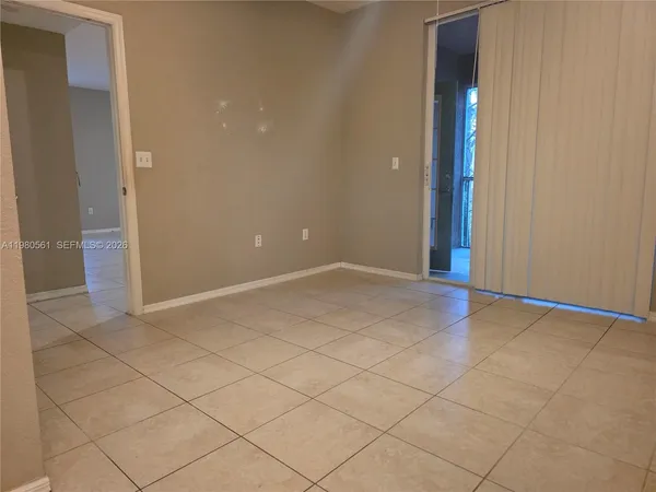an empty room with white walls and tiles