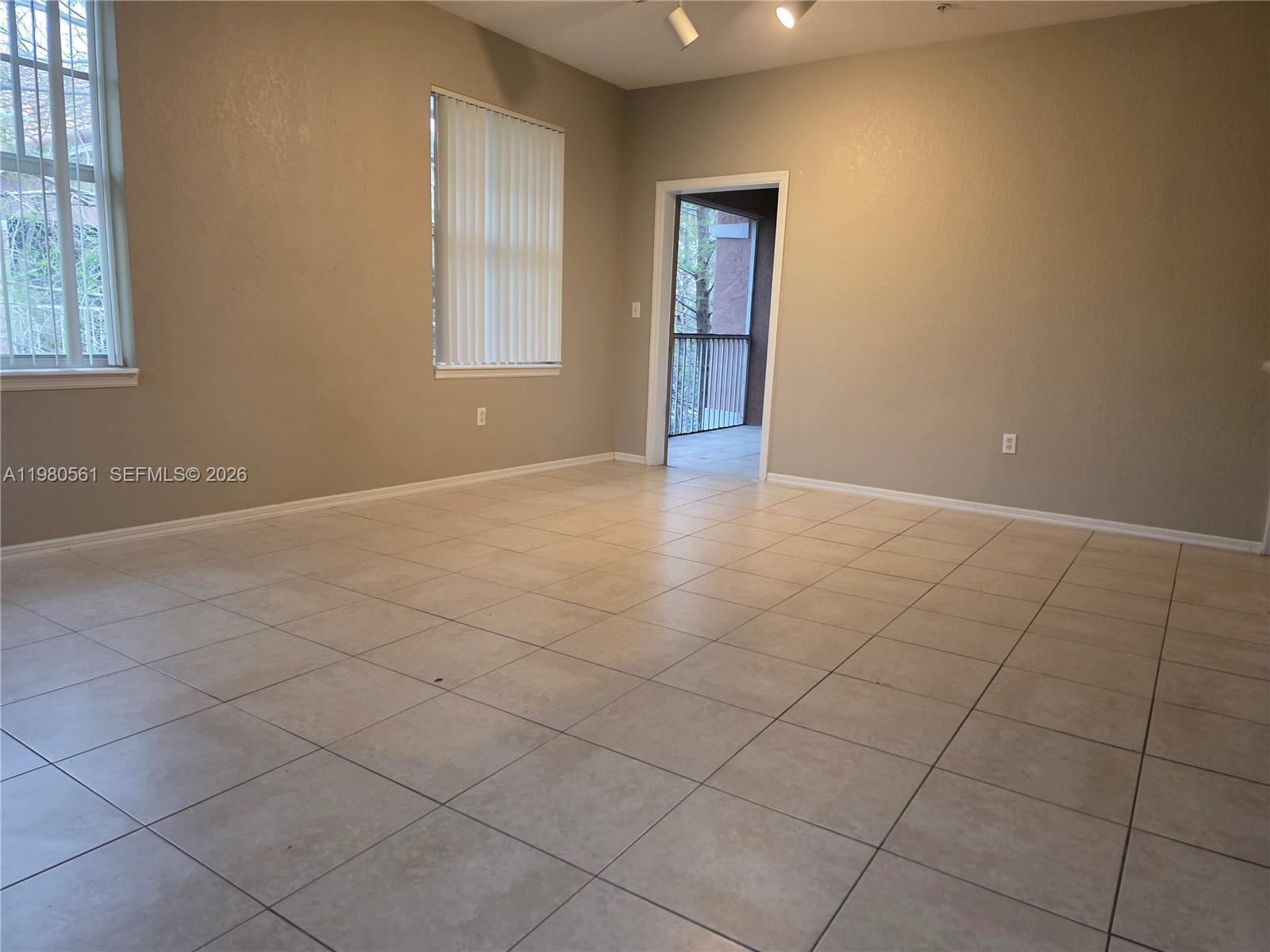 6660 West Sample Road, Unit 6660 Coral Springs, FL 33067 - Photo 2 of 30 an empty room with windows