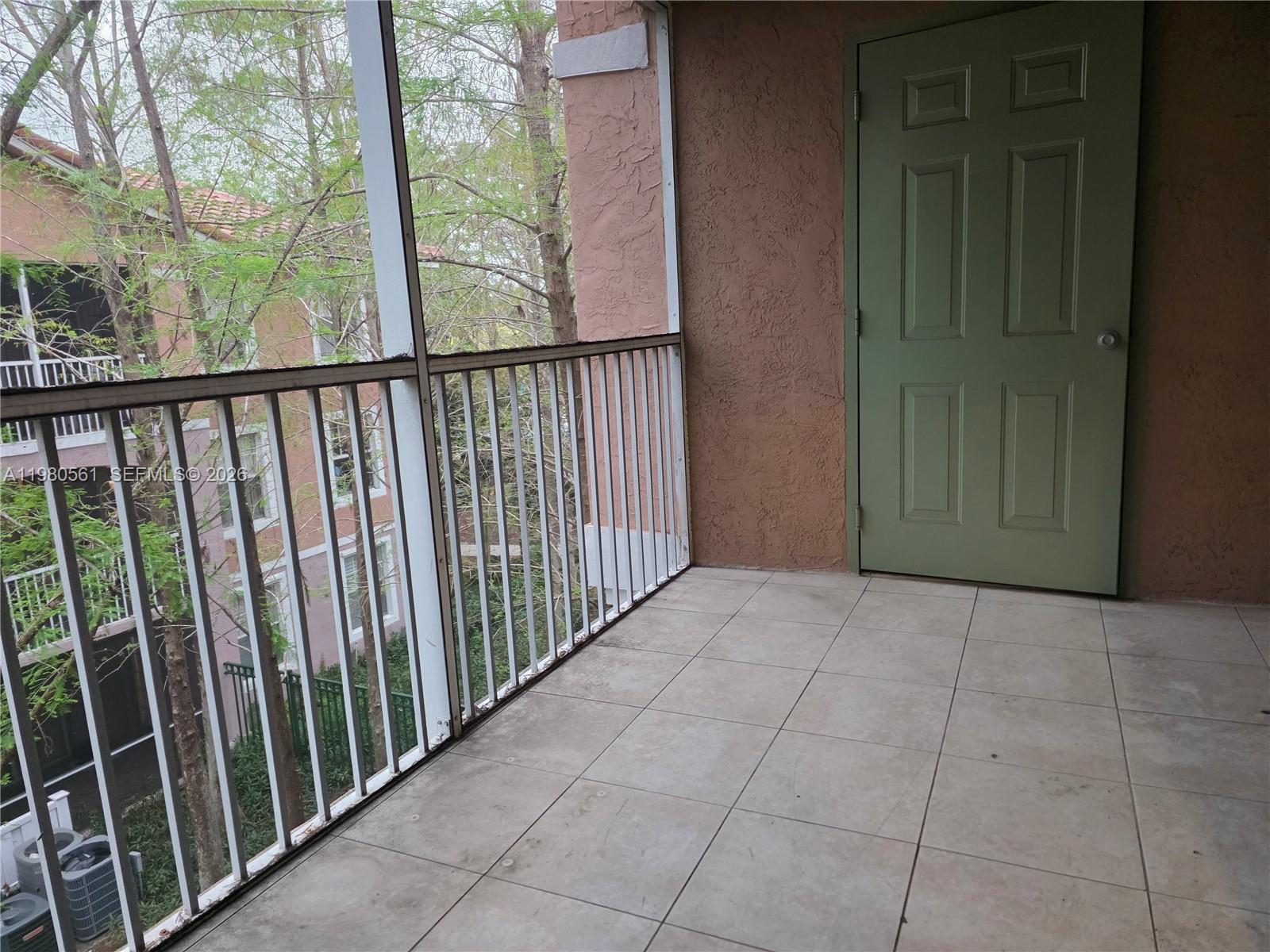 6660 West Sample Road, Unit 6660 Coral Springs, FL 33067 - Photo 21 of 30 a view of a porch with wooden floor