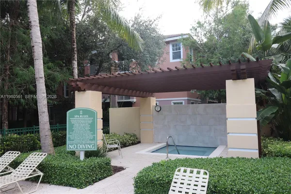 a view of swimming pool with palm trees