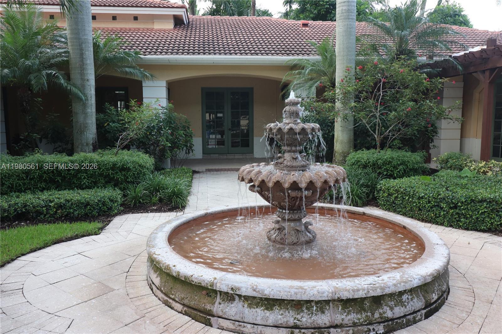 6660 West Sample Road, Unit 6660 Coral Springs, FL 33067 - Photo 28 of 30 a view of a house with fountain in front of fountain