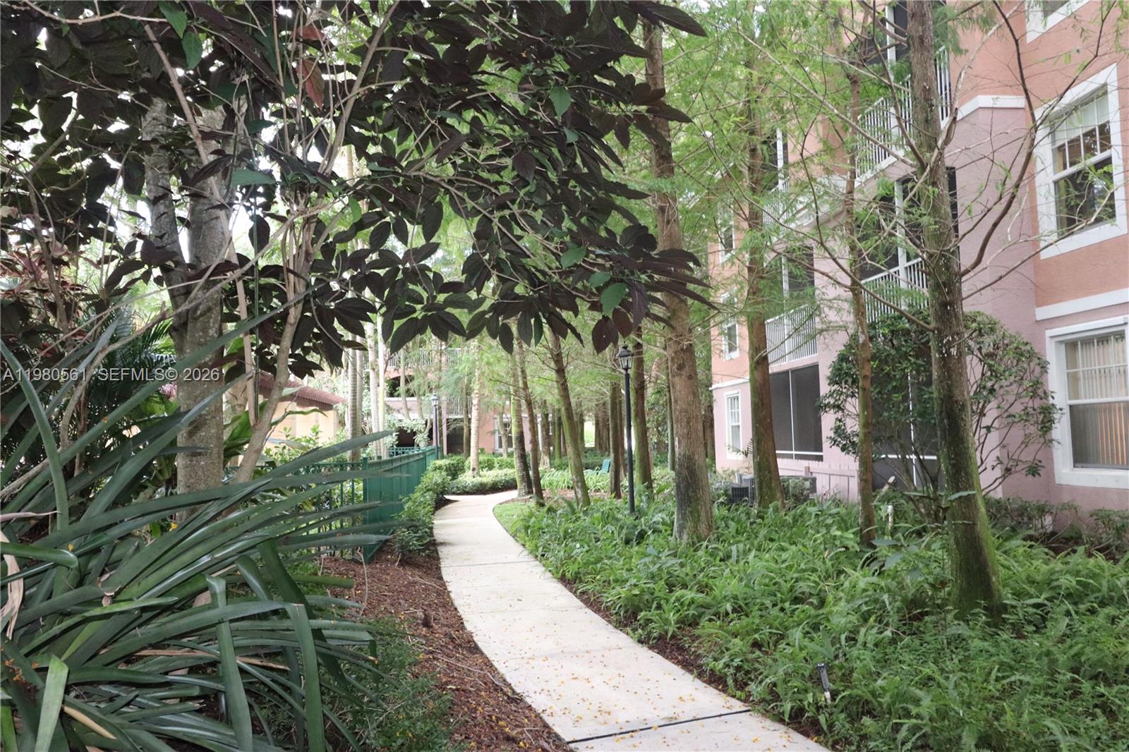 6660 West Sample Road, Unit 6660 Coral Springs, FL 33067 - Photo 30 of 30 a view of a pathway with a tree