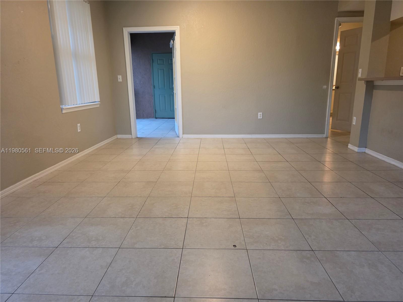 6660 West Sample Road, Unit 6660 Coral Springs, FL 33067 - Photo 3 of 30 a view of an empty room with a window