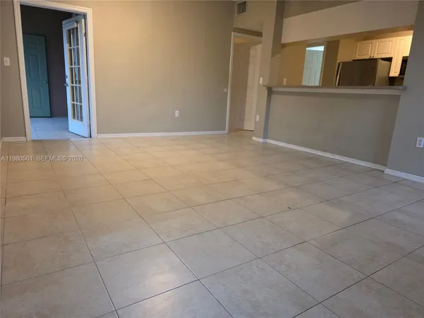 a view of a kitchen with an empty room
