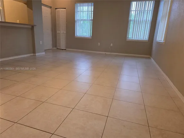 a view of an empty room with a window