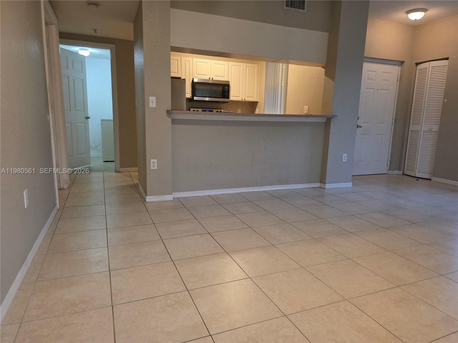 6660 West Sample Road, Unit 6660 Coral Springs, FL 33067 - Photo 6 of 30 a view of kitchen with a sink and a refrigerator