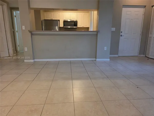 a view of kitchen with granite countertop cabinets and outdoor space
