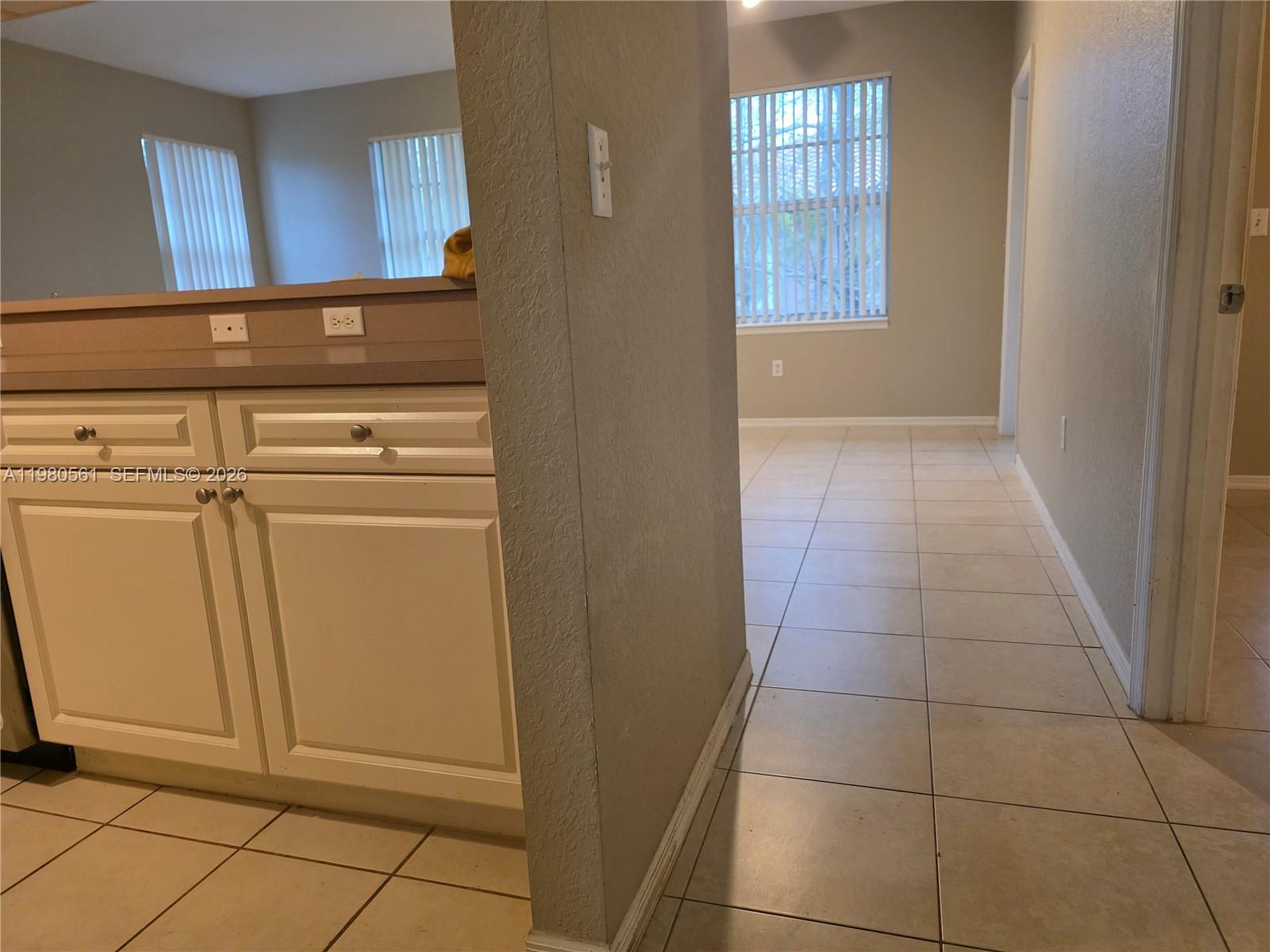 6660 West Sample Road, Unit 6660 Coral Springs, FL 33067 - Photo 10 of 30 a view of a hallway to rooms