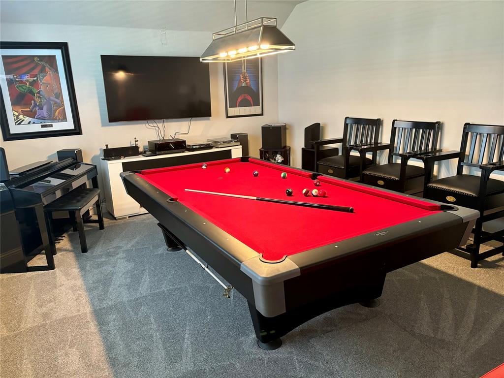 a room with pool table and flat screen tv