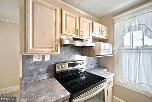 a kitchen with wooden cabinets and a stove top oven
