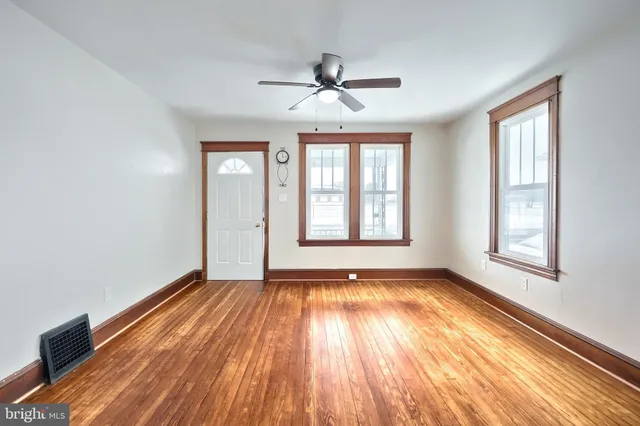 wooden floor in an empty room with a window
