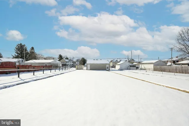 a view of a house with a snow in the yard