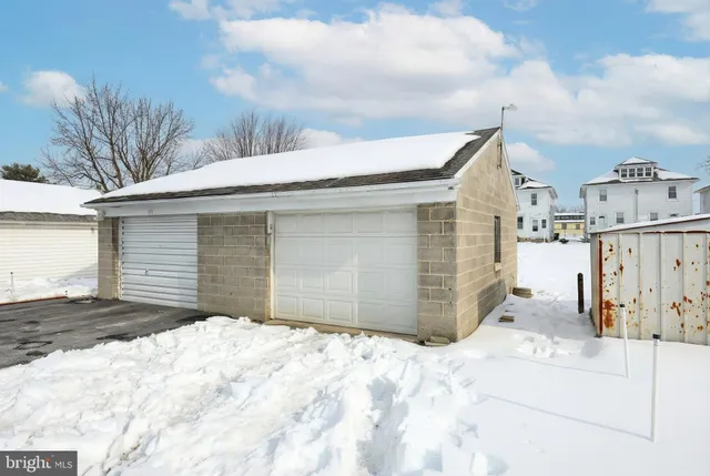 a view of a house with a snow in the yard
