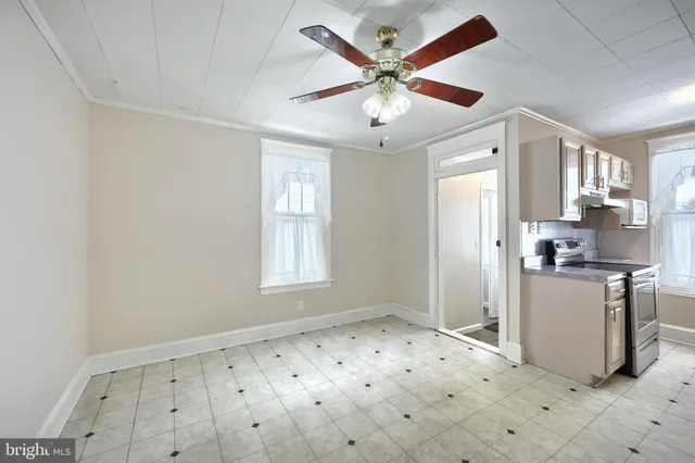 a view of a kitchen with a sink and dishwasher a refrigerator with wooden floor