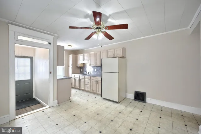 a room with white cabinets and white appliances