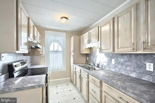 a kitchen with stainless steel appliances granite countertop a sink stove and cabinets