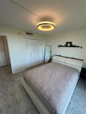 a spacious bedroom with a bed and a large window