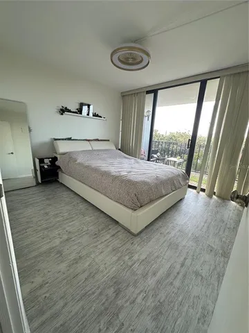 a bedroom with a bed and large window