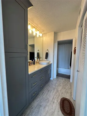 a bathroom with a sink mirror and toilet
