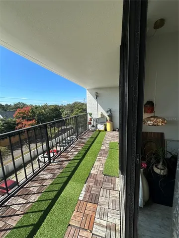 a view of a balcony with wooden floor