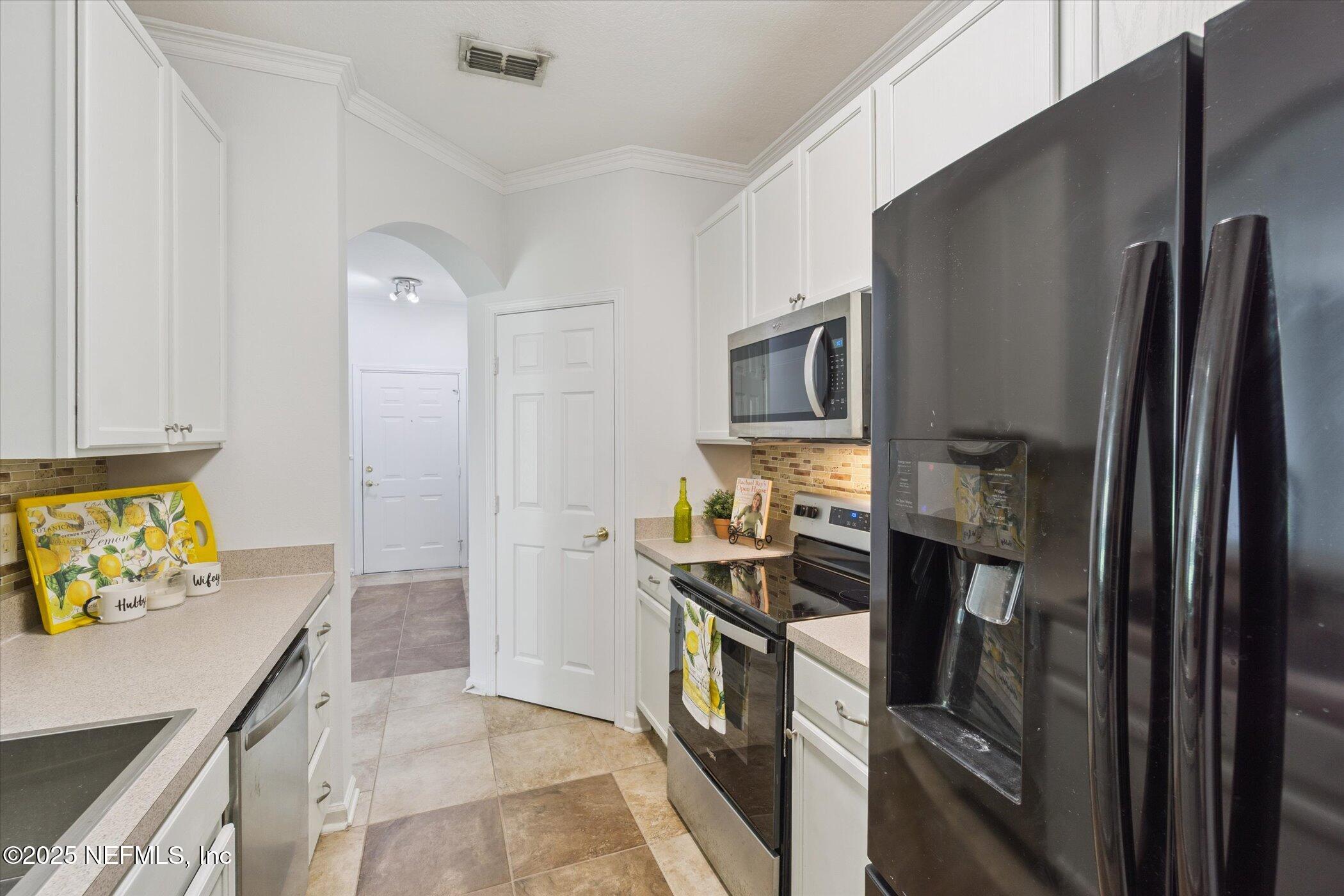 7990 Baymeadows Road East, Unit 201 Jacksonville, FL 32256 - Photo 11 of 43 a kitchen with a refrigerator stove and microwave