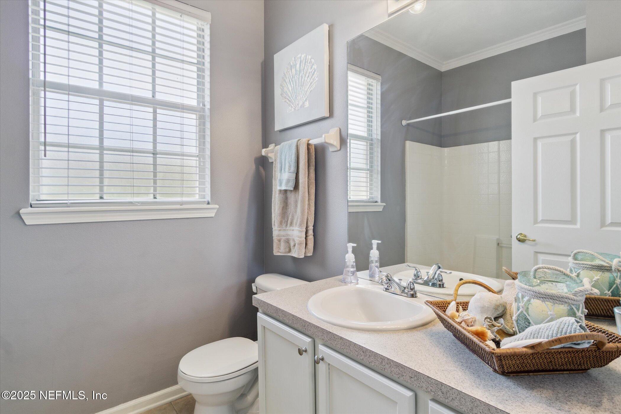 7990 Baymeadows Road East, Unit 201 Jacksonville, FL 32256 - Photo 19 of 43 a bathroom with a sink toilet and a mirror