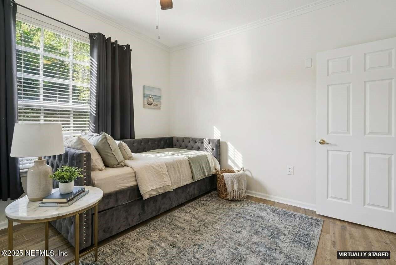 7990 Baymeadows Road East, Unit 201 Jacksonville, FL 32256 - Photo 22 of 43 a bedroom with a bed and a chair