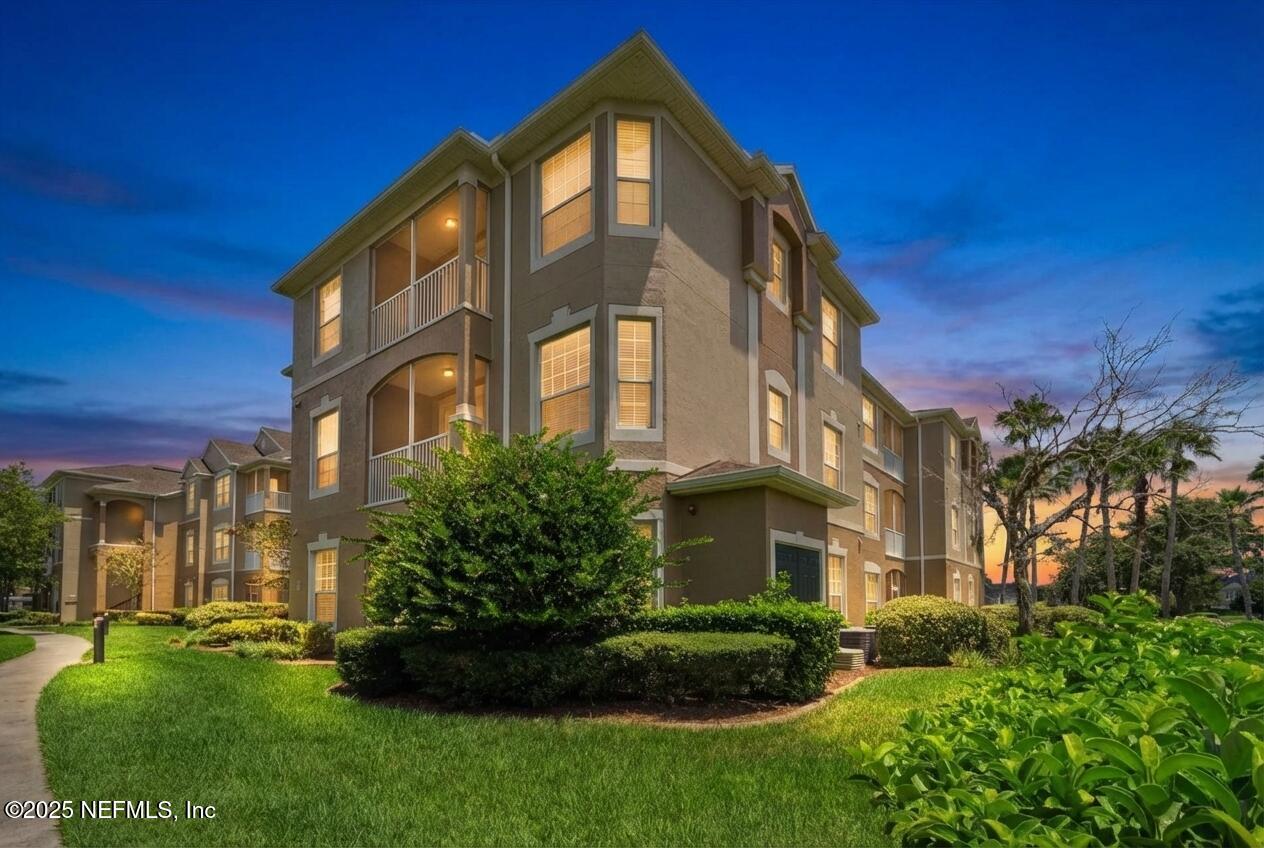7990 Baymeadows Road East, Unit 201 Jacksonville, FL 32256 - Photo 29 of 43 a front view of a residential apartment building with a yard